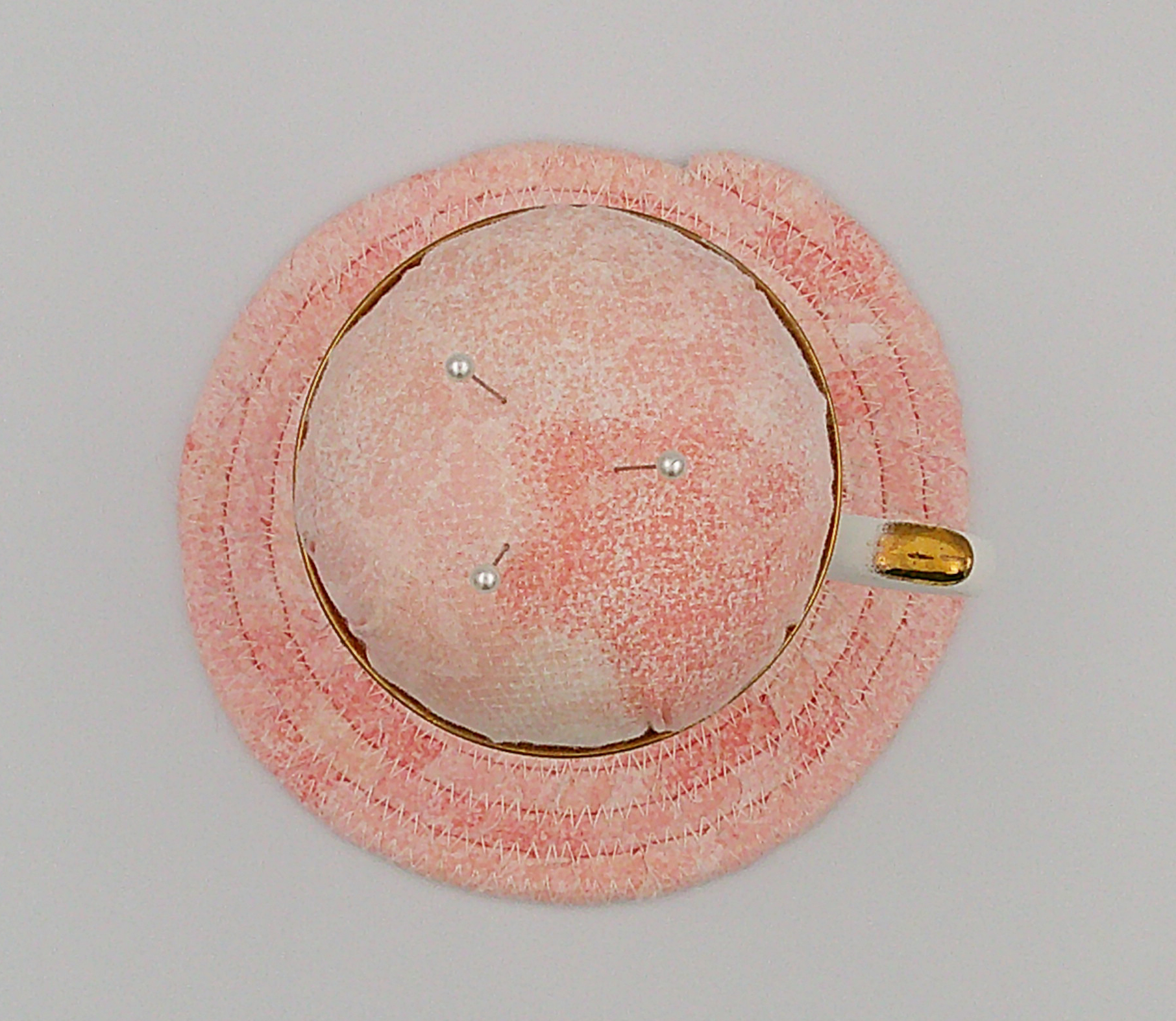 This is a view looking down at the pincushion sitting on the trivet. This is a view looking down at the pincushion sitting on the trivet.